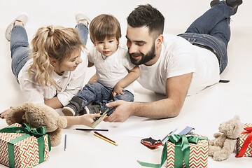 Image showing happy family with kid together and smiling at camera isolated on white