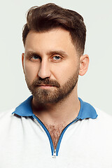 Image showing The serious man standing and looking at camera against white background.