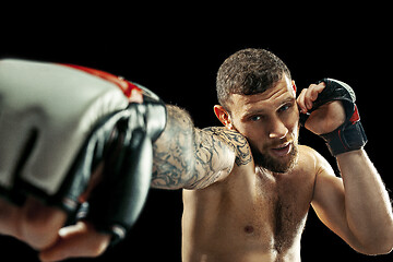 Image showing professional boxer boxing isolated on black studio background