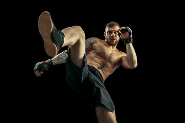 Image showing professional boxer boxing isolated on black studio background