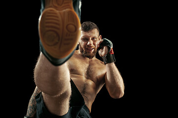 Image showing professional boxer boxing isolated on black studio background