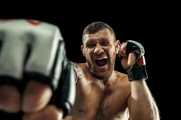 Image showing professional boxer boxing isolated on black studio background