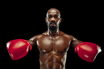 Image showing Hand of boxer over black background. Strength, attack and motion concept