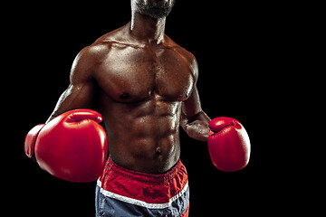 Image showing Hand of boxer over black background. Strength, attack and motion concept