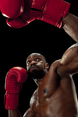 Image showing Hand of boxer over black background. Strength, attack and motion concept