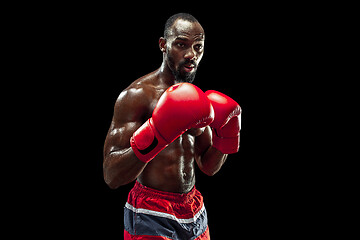 Image showing Hand of boxer over black background. Strength, attack and motion concept