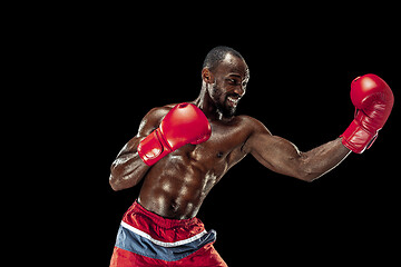 Image showing Hand of boxer over black background. Strength, attack and motion concept