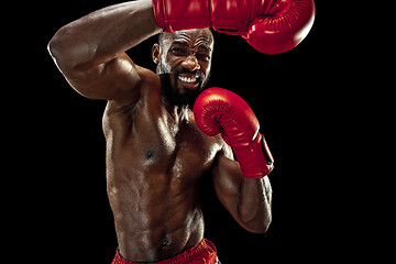 Image showing Hand of boxer over black background. Strength, attack and motion concept