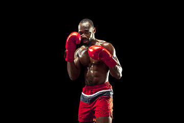 Image showing Hand of boxer over black background. Strength, attack and motion concept