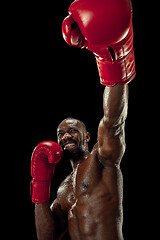 Image showing Hand of boxer over black background. Strength, attack and motion concept