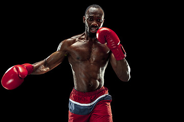 Image showing Hand of boxer over black background. Strength, attack and motion concept