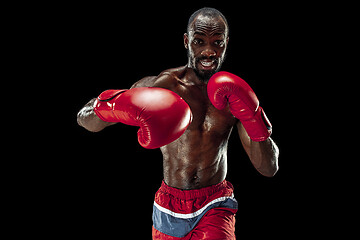 Image showing Hand of boxer over black background. Strength, attack and motion concept