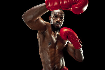 Image showing Hand of boxer over black background. Strength, attack and motion concept