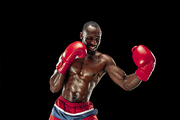 Image showing Hand of boxer over black background. Strength, attack and motion concept