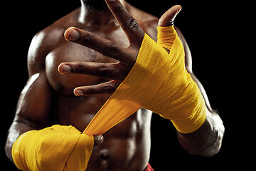 Image showing Afro American boxer is wrapping hands with bandage