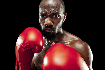 Image showing Hand of boxer over black background. Strength, attack and motion concept