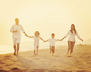 Image showing happy young family have fun on beach at sunset