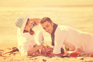 Image showing young couple enjoying  picnic on the beach