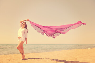 Image showing beautiful young woman on beach with scarf