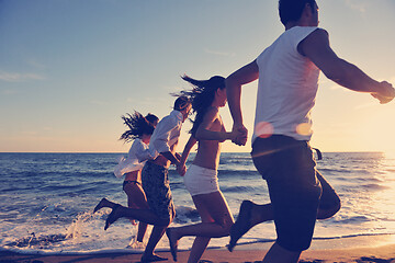 Image showing people group running on the beach