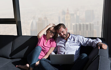 Image showing couple relaxing at  home using laptop computers