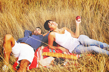 Image showing happy couple enjoying countryside picnic in long grass