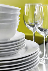 Image showing Stack of Commercial White Plates Bowls and Wine Glasses