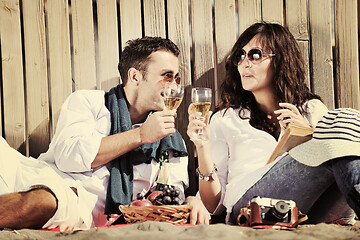 Image showing young couple enjoying  picnic on the beach