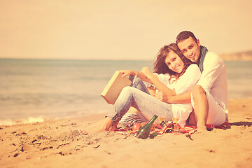 Image showing young couple enjoying  picnic on the beach