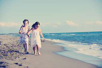 Image showing cute little girls running on beach