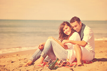 Image showing young couple enjoying  picnic on the beach