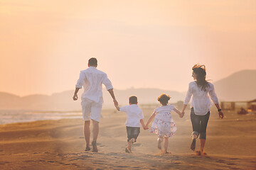 Image showing happy young family have fun on beach at sunset