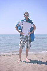 Image showing funny superhero standing on beach