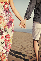 Image showing couple on beach with travel bag