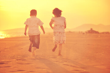 Image showing happy young family have fun on beach at sunset