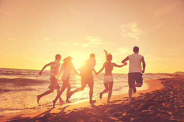 Image showing people group running on the beach