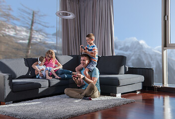 Image showing Happy family playing a video game