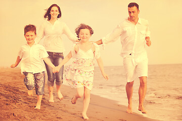 Image showing happy young family have fun on beach