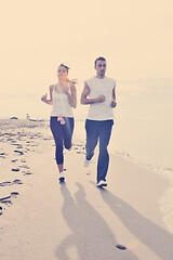 Image showing couple jogging on the beach