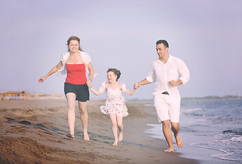 Image showing happy young family have fun on beach