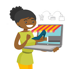 Image showing Young african-american woman shopping online.