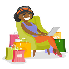 Image showing African woman using laptop for online shopping.