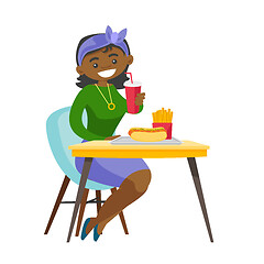 Image showing Young african-american woman eating fast food.