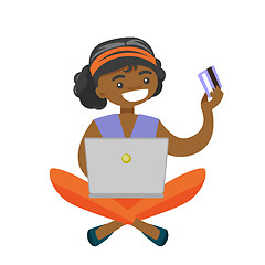 Image showing African woman using laptop for online shopping.