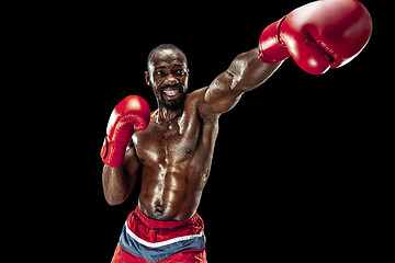 Image showing Hand of boxer over black background. Strength, attack and motion concept