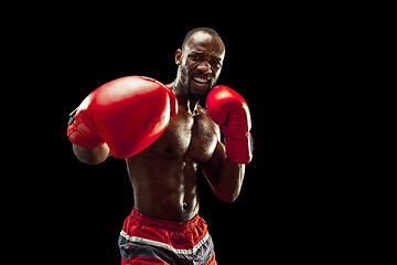 Image showing Hand of boxer over black background. Strength, attack and motion concept