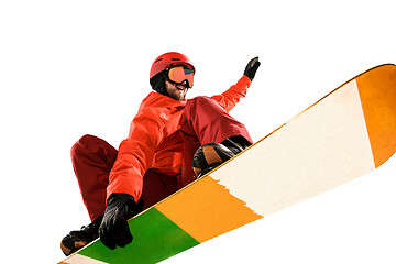 Image showing Portrait of young man in sportswear with snowboard isolated on a white background.