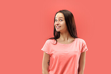 Image showing Beautiful woman looking suprised isolated on coral