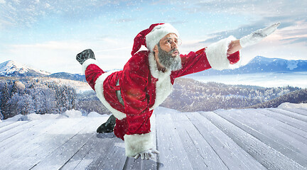 Image showing Santa Claus with traditional red white costume in front of white snow winter landscape panorama