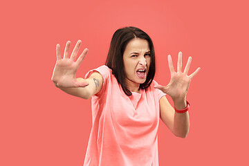 Image showing Let me think. Doubtful pensive woman with thoughtful expression making choice against coral background